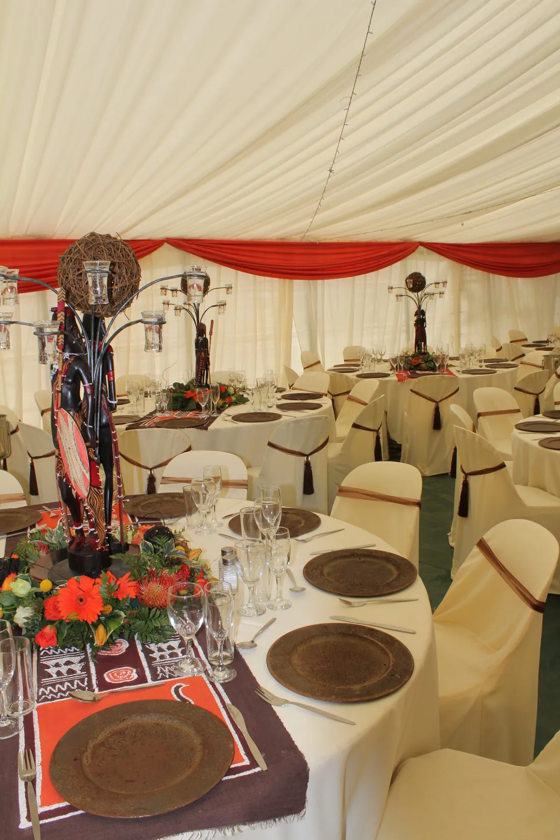 A corporate dinner with red draping and patterned linen