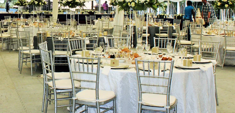 Silver chairs and round tables set for a function