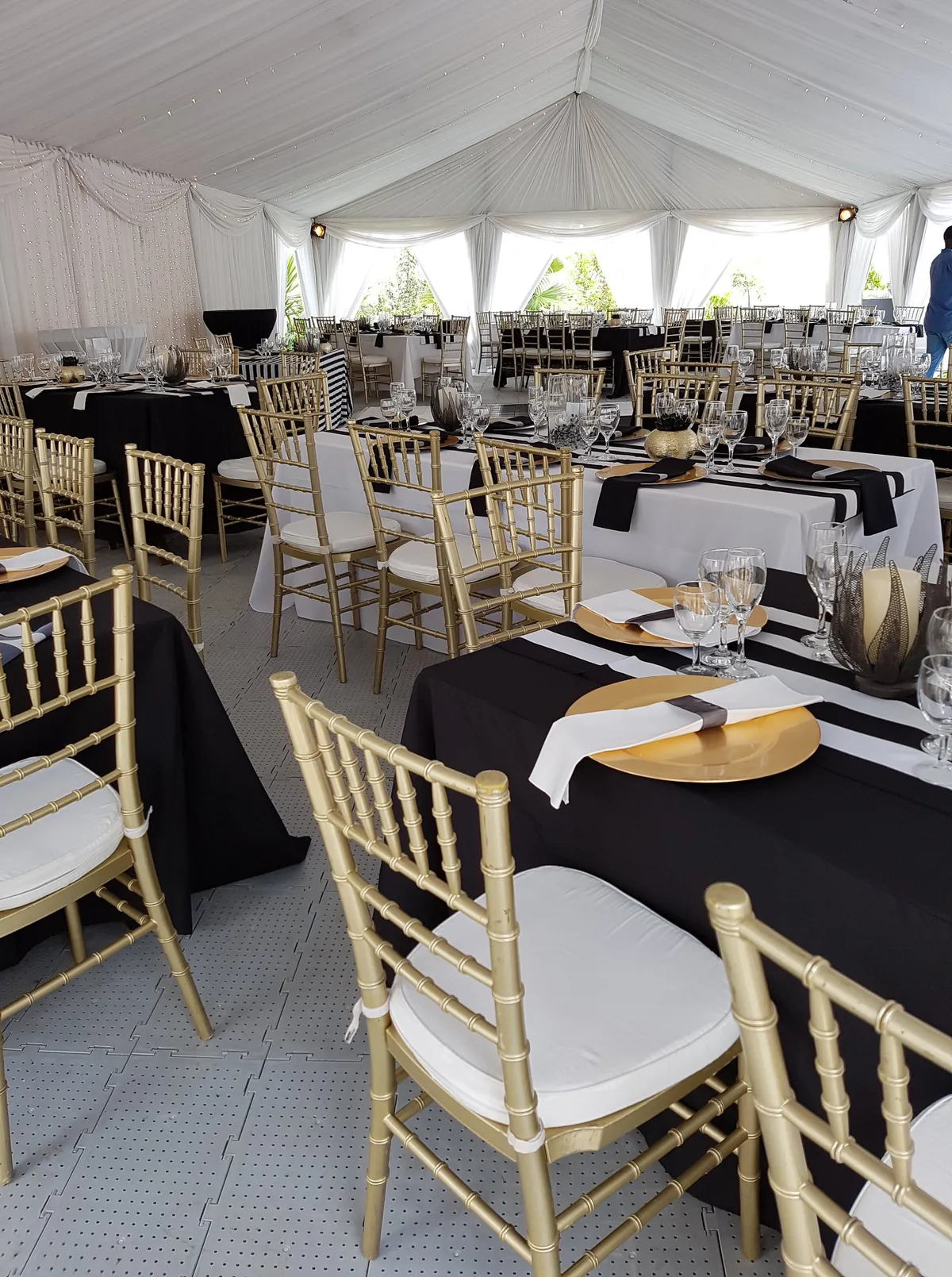 Gold Tiffany chairs at a table set with linen and glassware
